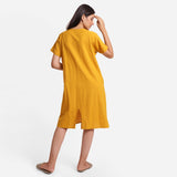 Back View of a Model wearing Mustard Cotton Flax Anti-Fit Dress