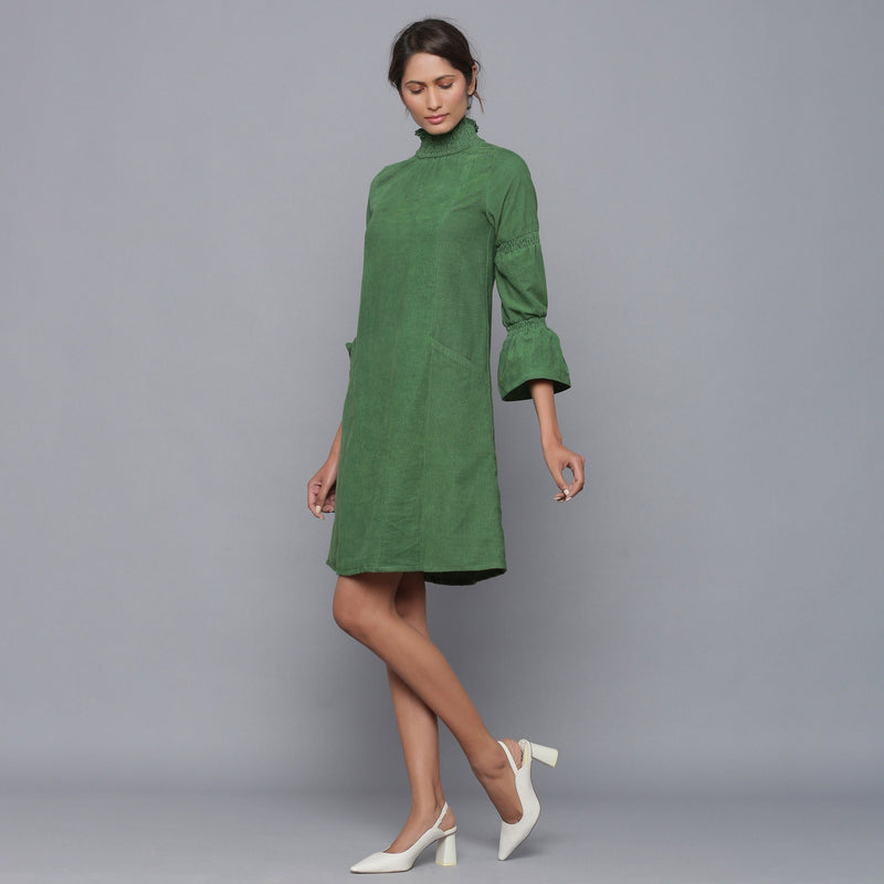 Left View of a Model wearing Moss Green Corduroy High Neck Dress