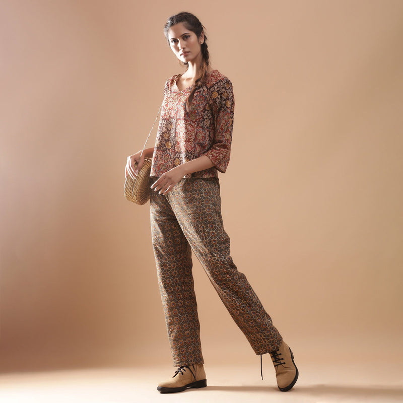 Left View of a Model wearing Muddy Red Top and Warm Muddy Green Pant Set
