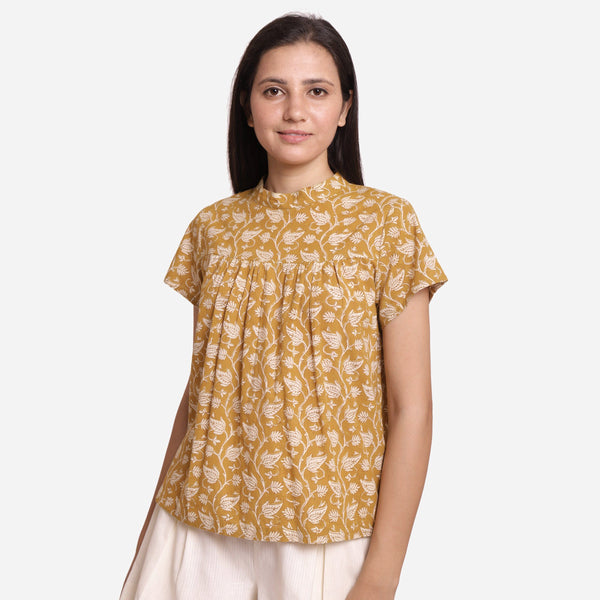 Front View of a Model wearing Mustard Bagru Print Relaxed Fit Top