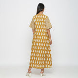 Back View of a Model wearing Mustard Block Printed Cotton Ankle Length Snug Dress