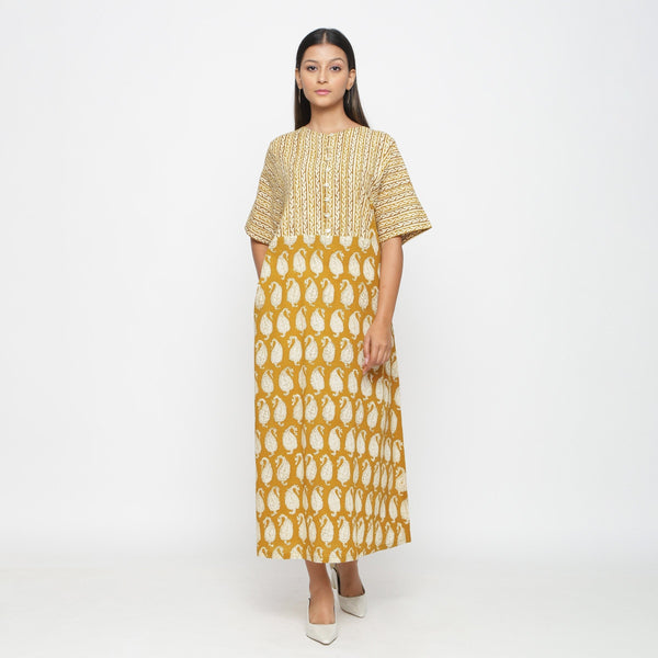 Front View of a Model wearing Mustard Block Printed Cotton Ankle Length Snug Dress