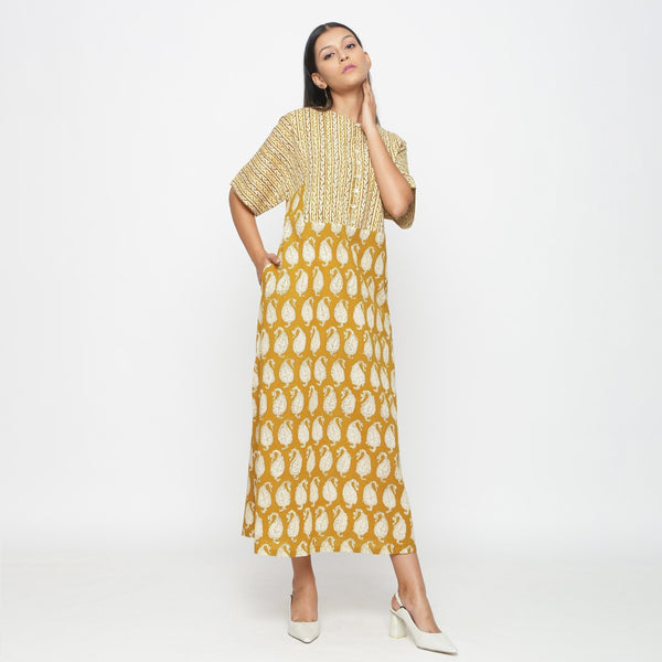Right View of a Model wearing Mustard Block Printed Cotton Ankle Length Snug Dress