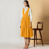 Left View of a Model wearing Mustard Cotton Flax Pinafore Midi Wrap Dress