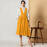 Front View of a Model wearing Mustard Cotton Flax Pinafore Midi Wrap Dress