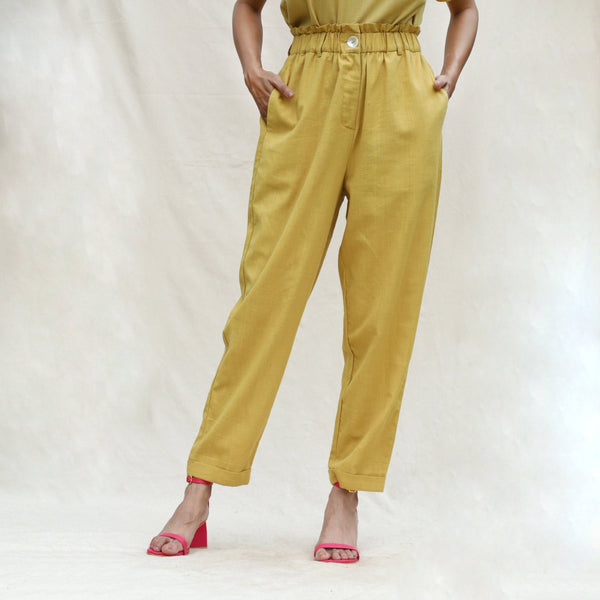 Front View of a Model wearing Mustard Handspun Cotton High-Rise Elasticated Paperbag Pant