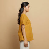 Right View of a Model wearing Mustard Cotton U-Neck Straight Top