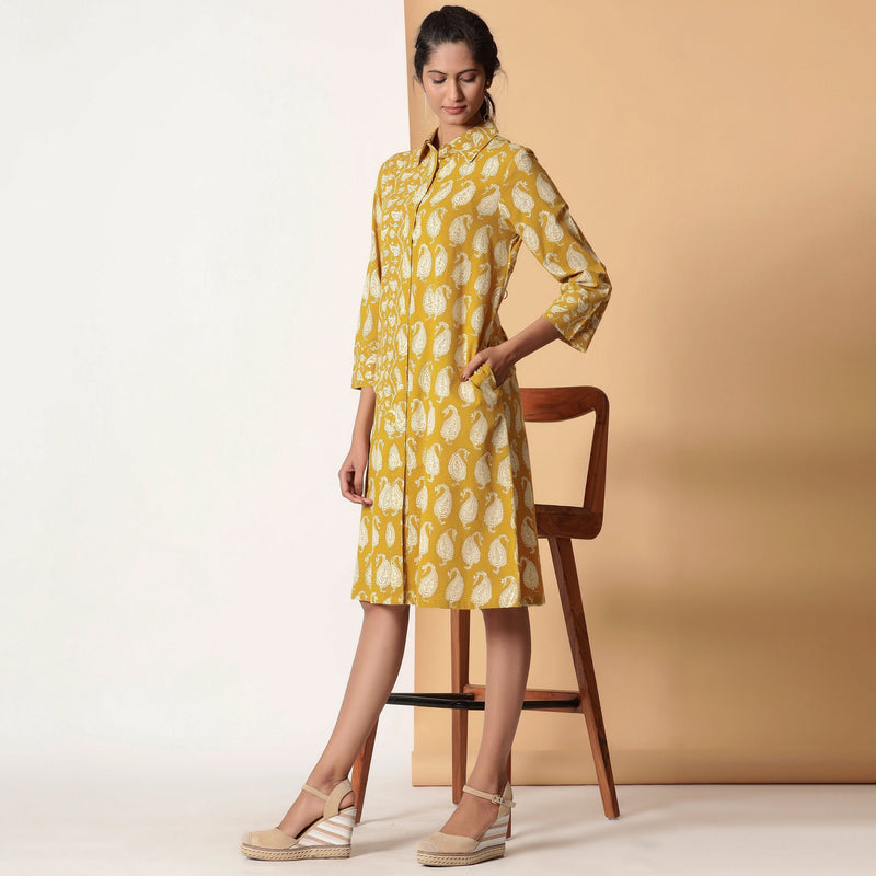 Left View of a Model wearing Mustard Paisley Bagru Block Printed Shirt Dress