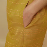 Left Detail of a Model wearing Mustard Paneled Striped Handwoven Pant