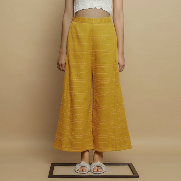 Front View of a Model wearing Mustard Paneled Striped Handwoven Pant
