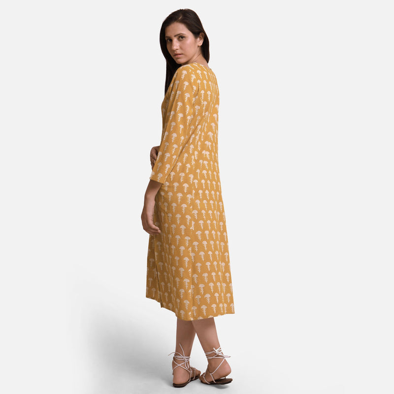 Left View of a Model wearing Mustard Block Print Princess Line Midi Cotton Dress