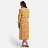 Back View of a Model wearing Mustard Block Print Princess Line Midi Cotton Dress