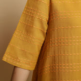 Front Detail of a Model wearing Mustard Striped Handwoven Godet Dress