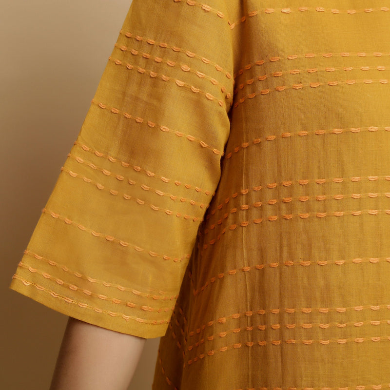 Front Detail of a Model wearing Mustard Striped Handwoven Godet Dress