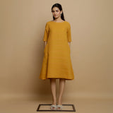 Front View of a Model wearing Mustard Striped Handwoven Godet Dress