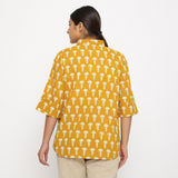 Back View of a Model wearing Mustard Block Printed Button-Down Shirt