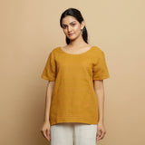 Front View of a Model wearing Mustard Cotton U-Neck Straight Top