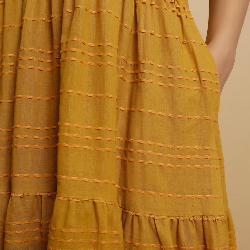 Front Detail of a Model wearing Mustard V-Neck Handwoven Tier Dress