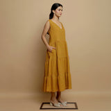 Right View of a Model wearing Mustard V-Neck Handwoven Tier Dress
