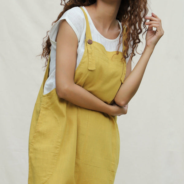 Front Detail of a Model wearing Mustard Vegetable Dyed Cotton Midi Dungaree Jumpsuit