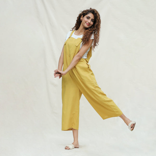 Front View of a Model wearing Mustard Vegetable Dyed Cotton Midi Dungaree Jumpsuit