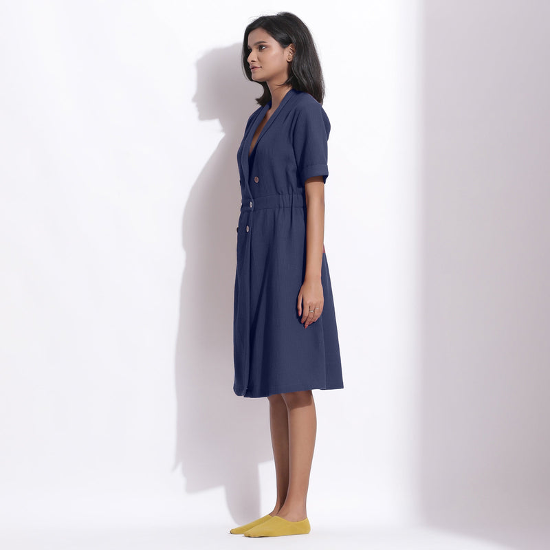 Left View of a Model wearing Navy Blue Cotton Waffle Knee Length Coat Dress
