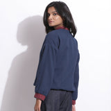 Back View of a Model wearing Reversible Blue Red Waffle Bomber Jacket