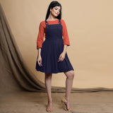 Front View of a Model wearing Navy Blue Cotton Flax Knee Length Criss-Cross Back Dress