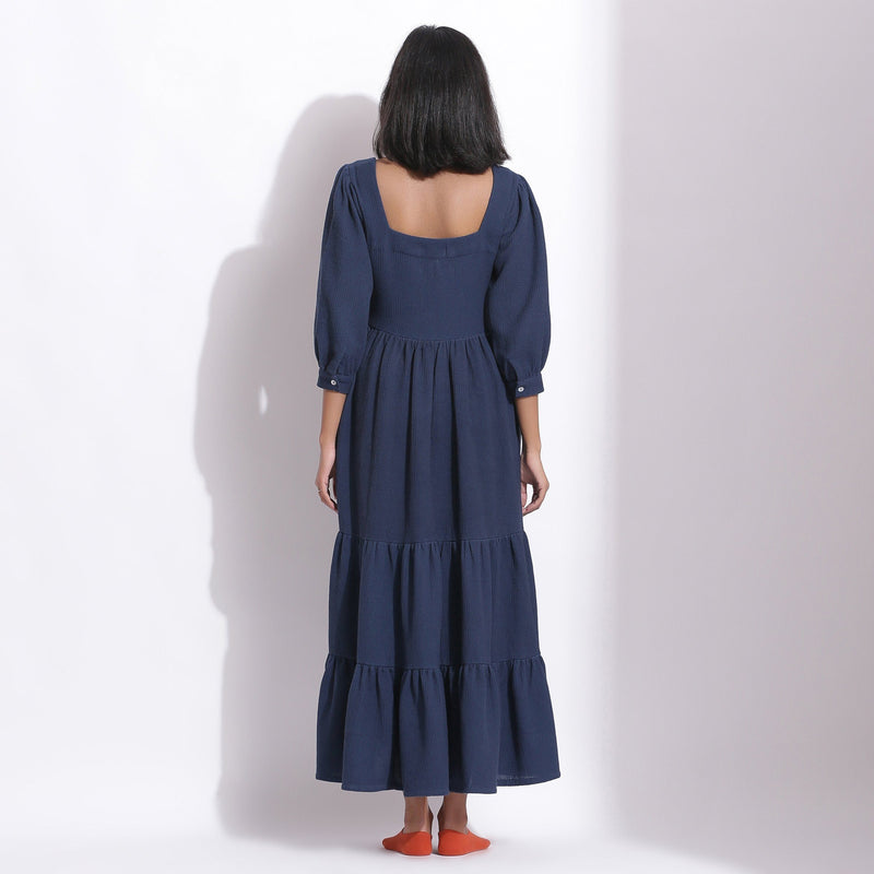Back View of a Model wearing Navy Blue Cotton Waffle Tier Maxi Dress