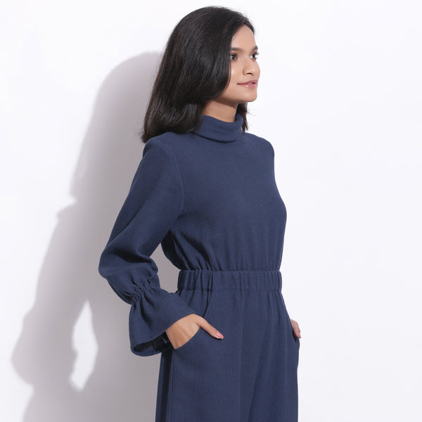Right View of a Model wearing Navy Blue Cotton Waffle Turtle Neck Overalls