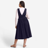 Back View of a Model wearing Navy Blue Deep Neck Pinafore Midi Wrap Dress