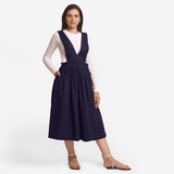 Front View of a Model wearing Navy Blue Deep Neck Pinafore Midi Wrap Dress