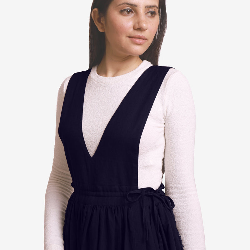 Front Detail of a Model wearing Navy Blue Deep Neck Pinafore Midi Wrap Dress
