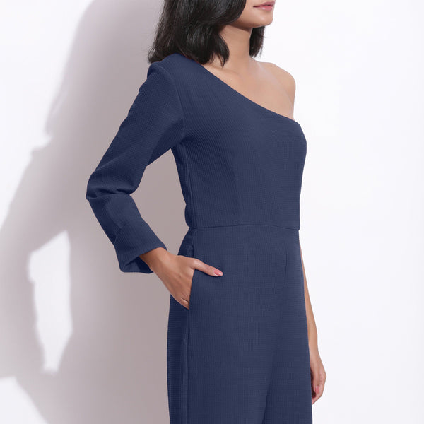 Right Detail of a Model wearing Navy Blue Honeycomb One-Shoulder Jumpsuit