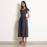 Left View of a Model wearing Navy Blue Striped Frilled Neck Flared Jumpsuit