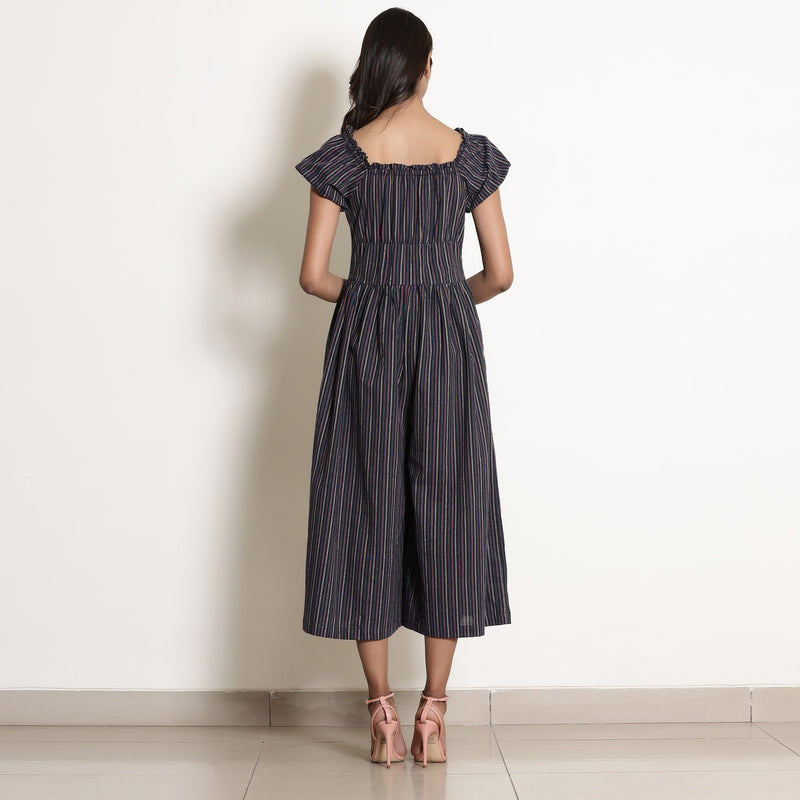 Back View of a Model wearing Navy Blue Striped Frilled Neck Flared Jumpsuit
