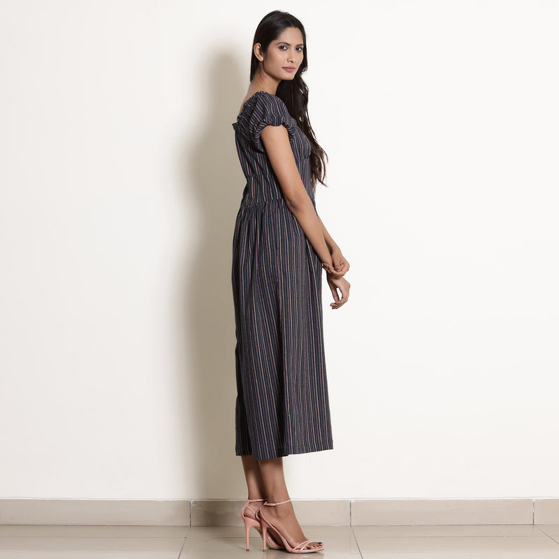 Right View of a Model wearing Navy Blue Striped Frilled Neck Flared Jumpsuit