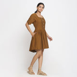 Right View of a Model wearing Oak Brown Cotton Button-Down Gathered Dress