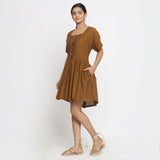 Left View of a Model wearing Oak Brown Cotton Button-Down Gathered Dress