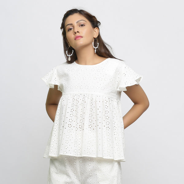 Front View of a Model wearing Off-White Cotton Schiffli Yoked Top
