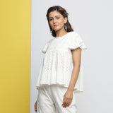 Left View of a Model wearing Off-White Cotton Schiffli Yoked Top
