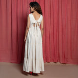 Back View of a Model wearing Off-White Embroidered Cotton Muslin Floor Length Tier Dress
