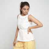 Front View of a Model wearing Ruffled Off-White Cotton Peplum Top