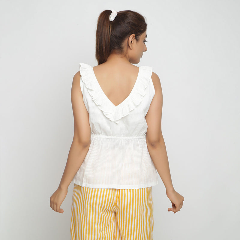 Back View of a Model wearing Ruffled Off-White Cotton Peplum Top
