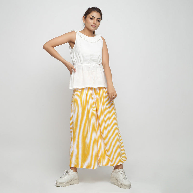 Front View of a Model wearing Off-White Peplum Top and Wide Legged Pant Set