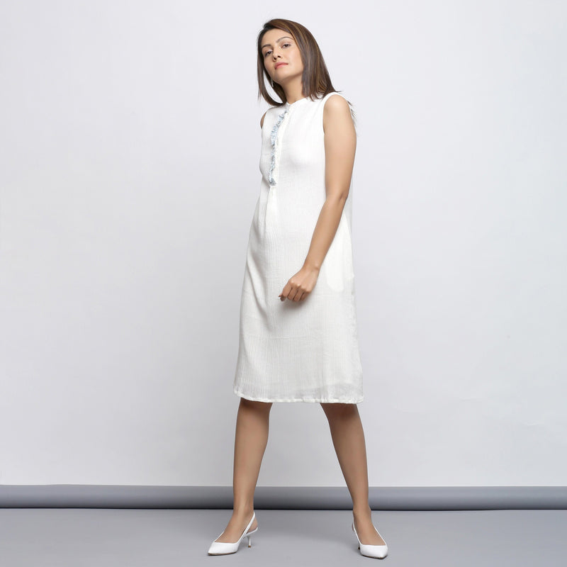 Left View of a Model wearing Off-White Button-Down Shift Dress