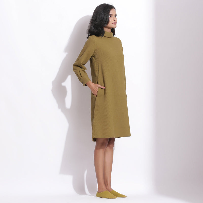 Right View of a Model wearing Olive Green Warm Cotton Waffle Knee Length Shift Dress
