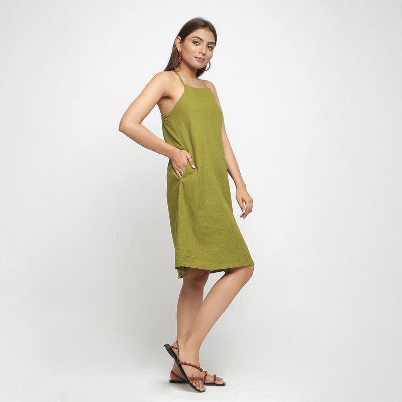 Right View of a Model wearing Olive Green Criss-Cross Cotton A-Line Dress