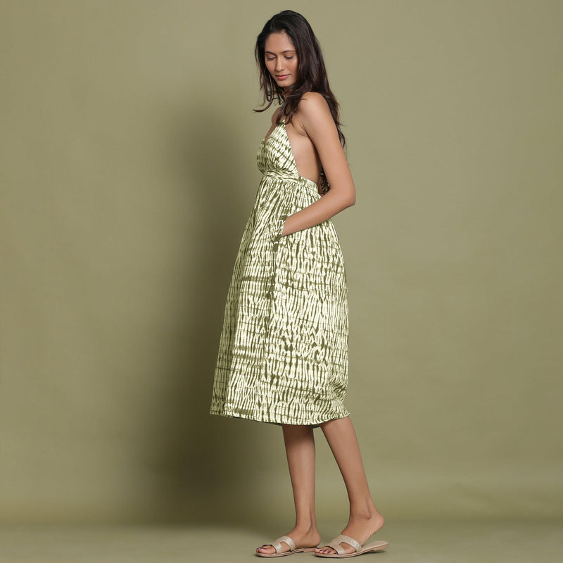 Left View of a Model wearing Olive Green Shibori Halter Neck Gathered Dress