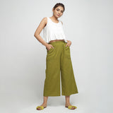 Front View of a Model wearing Olive Green Cotton Mid-Rise Elasticated Wide Legged Pant